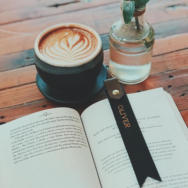 Coffee, book, and water on table