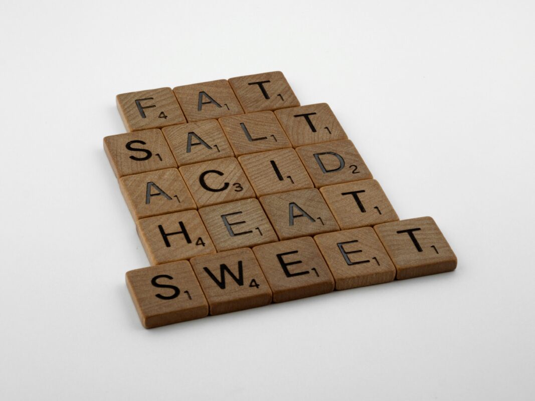 Scrabble tiles spelling fat, sweet, salt, acid, heat