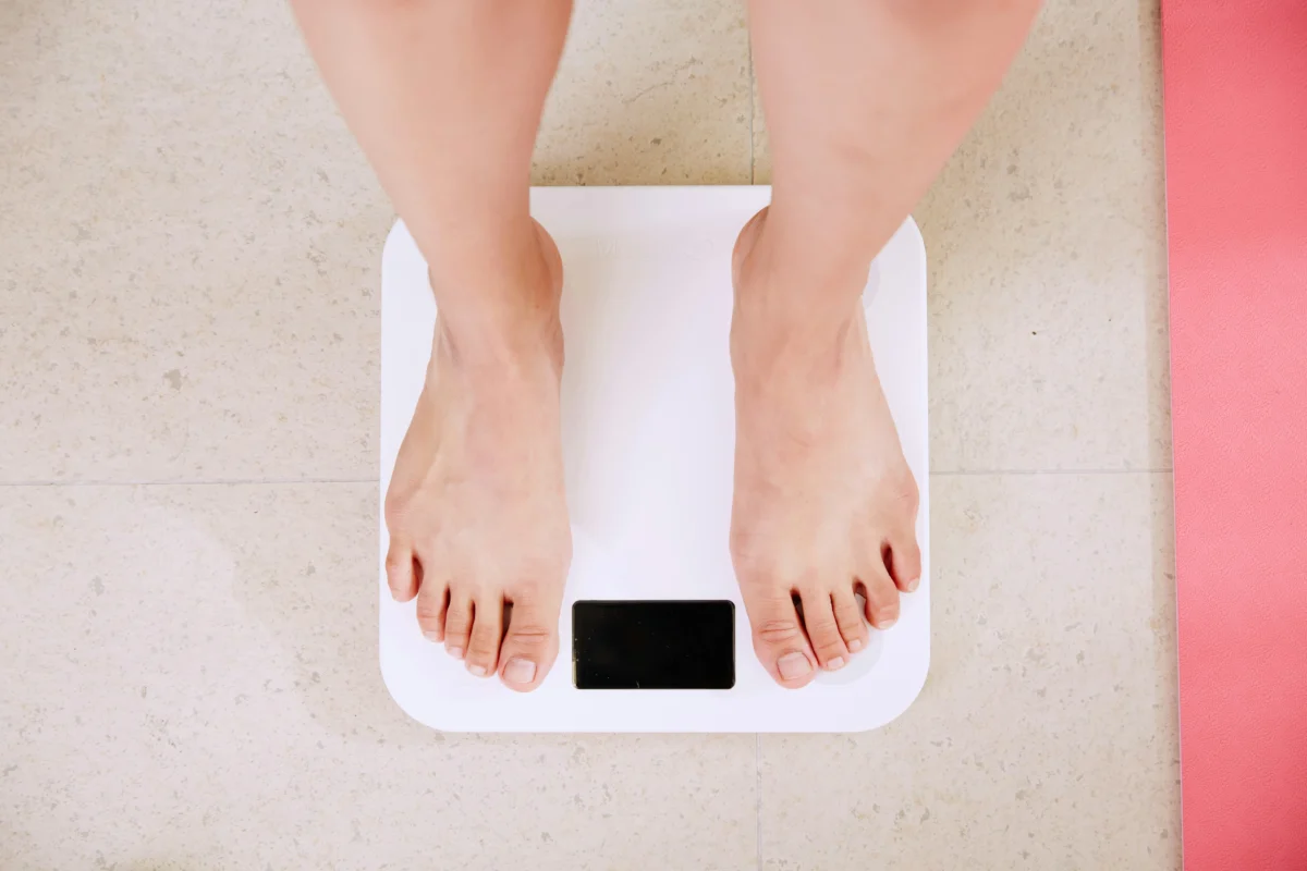 Feet standing on a digital bathroom scale